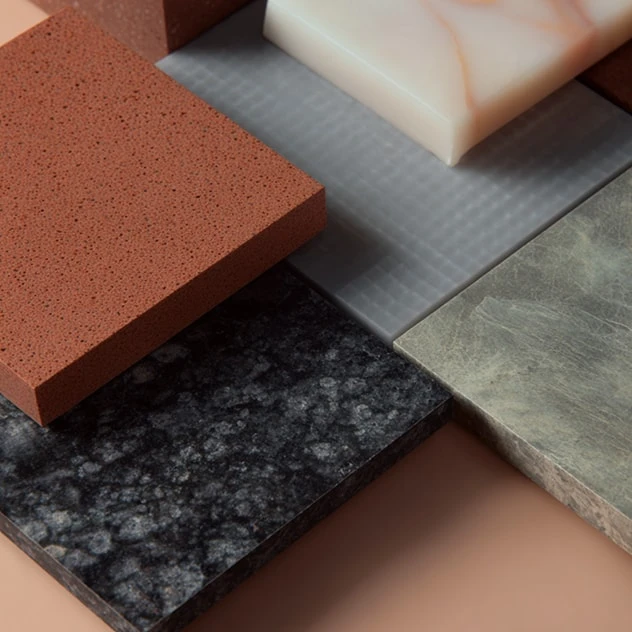 Overlapping terracotta, marble and dark granite material samples